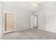 Bright bedroom with carpet, ceiling fan, and multiple doors for closet and hallway access at 2311 E Hartford Ave # 29, Phoenix, AZ 85022