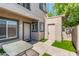 Charming townhome entrance with a small yard, featuring a table and updated neutral paint at 2311 E Hartford Ave # 29, Phoenix, AZ 85022