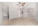 Open-concept living room featuring neutral paint, tile floors, stairs, and modern ceiling fan at 2311 E Hartford Ave # 29, Phoenix, AZ 85022