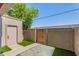 Private patio area featuring artificial grass and a secure gate at 2311 E Hartford Ave # 29, Phoenix, AZ 85022