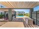 View of the community pool through a shaded pergola at 2311 E Hartford Ave # 29, Phoenix, AZ 85022