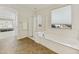 Bathroom featuring a soaking tub, a walk-in glass shower, neutral color palette, and natural light at 2501 S Roanoke St, Gilbert, AZ 85295