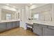 Elegant primary bathroom featuring double sinks, vanity seating, and modern fixtures and finishes at 2501 S Roanoke St, Gilbert, AZ 85295