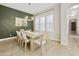Bright dining room with a large table, neutral decor, and an accent wall with a cactus print at 2501 S Roanoke St, Gilbert, AZ 85295