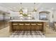 Stunning kitchen with white cabinetry, a large island with seating, and pendant lighting fixtures at 2501 S Roanoke St, Gilbert, AZ 85295