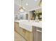 Close-up of a kitchen island featuring a farmhouse sink and stainless steel dishwasher at 2501 S Roanoke St, Gilbert, AZ 85295