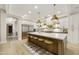Spacious kitchen featuring a large island with seating, stainless steel appliances, and white cabinetry at 2501 S Roanoke St, Gilbert, AZ 85295