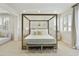 This airy main bedroom features a canopy bed with neutral bedding, bench seating, and lovely views from the bright windows at 2501 S Roanoke St, Gilbert, AZ 85295