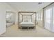 Bright main bedroom with plantation shutters, a canopy bed, an ensuite sitting room, and recessed lighting at 2501 S Roanoke St, Gilbert, AZ 85295