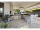 Inviting outdoor kitchen with modern grill, bar seating, and pavers, perfect for alfresco dining at 2501 S Roanoke St, Gilbert, AZ 85295