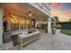 Covered patio with an outdoor lounge, ceiling fans, and a view of the backyard with a pool and grassy area at 2501 S Roanoke St, Gilbert, AZ 85295