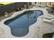 Aerial view of a backyard pool with a baja shelf, surrounded by mature landscaping and patio seating at 2501 S Roanoke St, Gilbert, AZ 85295