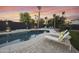 Relaxing backyard oasis with a sparkling pool, comfortable lounge chairs, and mature landscaping at 2501 S Roanoke St, Gilbert, AZ 85295