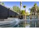 Backyard pool with a waterfall feature and surrounded by lush greenery for an eye-catching space at 2501 S Roanoke St, Gilbert, AZ 85295