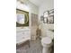 Stylish powder room featuring patterned tile floor, decorative mirror, and updated vanity at 2501 S Roanoke St, Gilbert, AZ 85295
