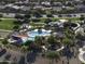Aerial view of a neighborhood park featuring a pool, waterslide, green spaces, and walking paths at 2512 E Katrina Trl, Casa Grande, AZ 85194