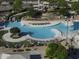 Aerial view of community pool with winding waterslides, lounge seating, and surrounding landscaping at 2512 E Katrina Trl, Casa Grande, AZ 85194