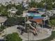 An aerial view showcases a park with pool, playground, slides, and shaded seating areas at 2512 E Katrina Trl, Casa Grande, AZ 85194