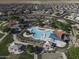 Aerial view of community park with pool, water slides, picnic tables, and playground amenities in a Gathering neighborhood at 2512 E Katrina Trl, Casa Grande, AZ 85194