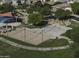 View of a community park with a playground, basketball court, and ample green spaces for recreation at 2512 E Katrina Trl, Casa Grande, AZ 85194