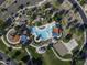 Aerial view of community park with pool, water slides, picnic tables, volleyball court, green space and playground at 2512 E Katrina Trl, Casa Grande, AZ 85194