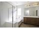 Bright bathroom featuring a glass shower, soaking tub, and double sink vanity with framed mirror at 2512 E Katrina Trl, Casa Grande, AZ 85194