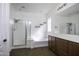 Clean bathroom featuring a glass enclosed shower and separate soaking tub with a brown vanity at 2512 E Katrina Trl, Casa Grande, AZ 85194