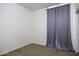 Bedroom with neutral carpet flooring and a large window covered with gray curtains at 2512 E Katrina Trl, Casa Grande, AZ 85194