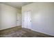 Bedroom with carpet flooring, features an open door and closet with sliding doors at 2512 E Katrina Trl, Casa Grande, AZ 85194