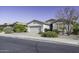 Single-story residence featuring a two-car garage complemented by drought-resistant landscaping at 2512 E Katrina Trl, Casa Grande, AZ 85194