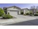 Inviting single-story house with a two-car garage and well-maintained front yard landscaping at 2512 E Katrina Trl, Casa Grande, AZ 85194