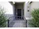 Charming gated front porch showcasing desert landscaping and a decorative front door at 2512 E Katrina Trl, Casa Grande, AZ 85194