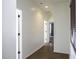 Well-lit hallway with tile flooring, leading to other rooms in the home at 2512 E Katrina Trl, Casa Grande, AZ 85194