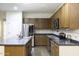 Well-lit kitchen features an island, stainless steel appliances, tile backsplash and countertops at 2512 E Katrina Trl, Casa Grande, AZ 85194