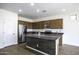Bright kitchen with an island, stainless steel appliances, tile backsplash, and tile flooring at 2512 E Katrina Trl, Casa Grande, AZ 85194