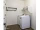 Laundry room features a washer, dryer, a shelf and a clothing rack at 2512 E Katrina Trl, Casa Grande, AZ 85194