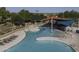 Aerial view of community pool featuring water play area, shaded seating, loungers, and splash pad amenity at 2512 E Katrina Trl, Casa Grande, AZ 85194