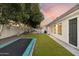 Private backyard featuring a lush lawn, trampoline, well-maintained landscaping, and an outdoor grilling area, perfect for recreation at 2625 N 24Th St # 15, Mesa, AZ 85213