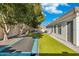 Expansive backyard with artificial grass, a trampoline, and a charming patio area at 2625 N 24Th St # 15, Mesa, AZ 85213