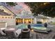 Luxurious backyard with a sparkling pool, spa, outdoor seating, fire pit, and manicured landscaping for relaxation at 2625 N 24Th St # 15, Mesa, AZ 85213