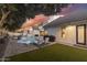 Spacious backyard with a pool, lounge chairs, pristine landscaping, and an outdoor grilling area, ideal for entertaining at 2625 N 24Th St # 15, Mesa, AZ 85213