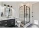 Bathroom featuring black and white tile floors, a black vanity, and a glass enclosed shower at 2625 N 24Th St # 15, Mesa, AZ 85213