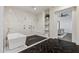 Bright bathroom featuring a modern tub, expansive shower with black rock floor, and beautiful marble accents at 2625 N 24Th St # 15, Mesa, AZ 85213