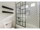 Modern bathroom features a subway tile shower with black trim and floating wood shelves at 2625 N 24Th St # 15, Mesa, AZ 85213