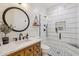 Charming bathroom featuring a vanity with drawers, round mirror and a tiled shower with glass door at 2625 N 24Th St # 15, Mesa, AZ 85213