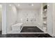 Bright bathroom featuring a modern tub, expansive shower with black rock floor, and beautiful marble accents at 2625 N 24Th St # 15, Mesa, AZ 85213