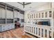 Bedroom with hardwood floors, custom gray shelving, a built-in desk, and a bunkbed near a window at 2625 N 24Th St # 15, Mesa, AZ 85213