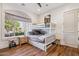 Bright bedroom features a white bunk bed with a pull-out trundle and a window with wooden floors at 2625 N 24Th St # 15, Mesa, AZ 85213