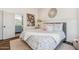 Charming bedroom with floral bedding, decorative mirror and view of a bathroom with blue cabinets at 2625 N 24Th St # 15, Mesa, AZ 85213