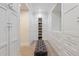 Walk-in closet with custom white cabinets, drawers, and shelving providing ample storage and organization at 2625 N 24Th St # 15, Mesa, AZ 85213